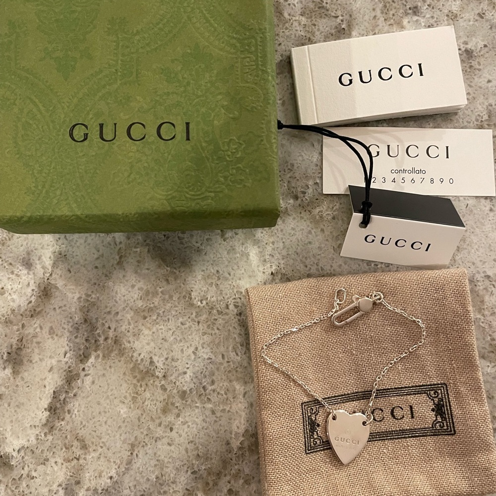 Gucci sterling silver heart bracelet with trademark